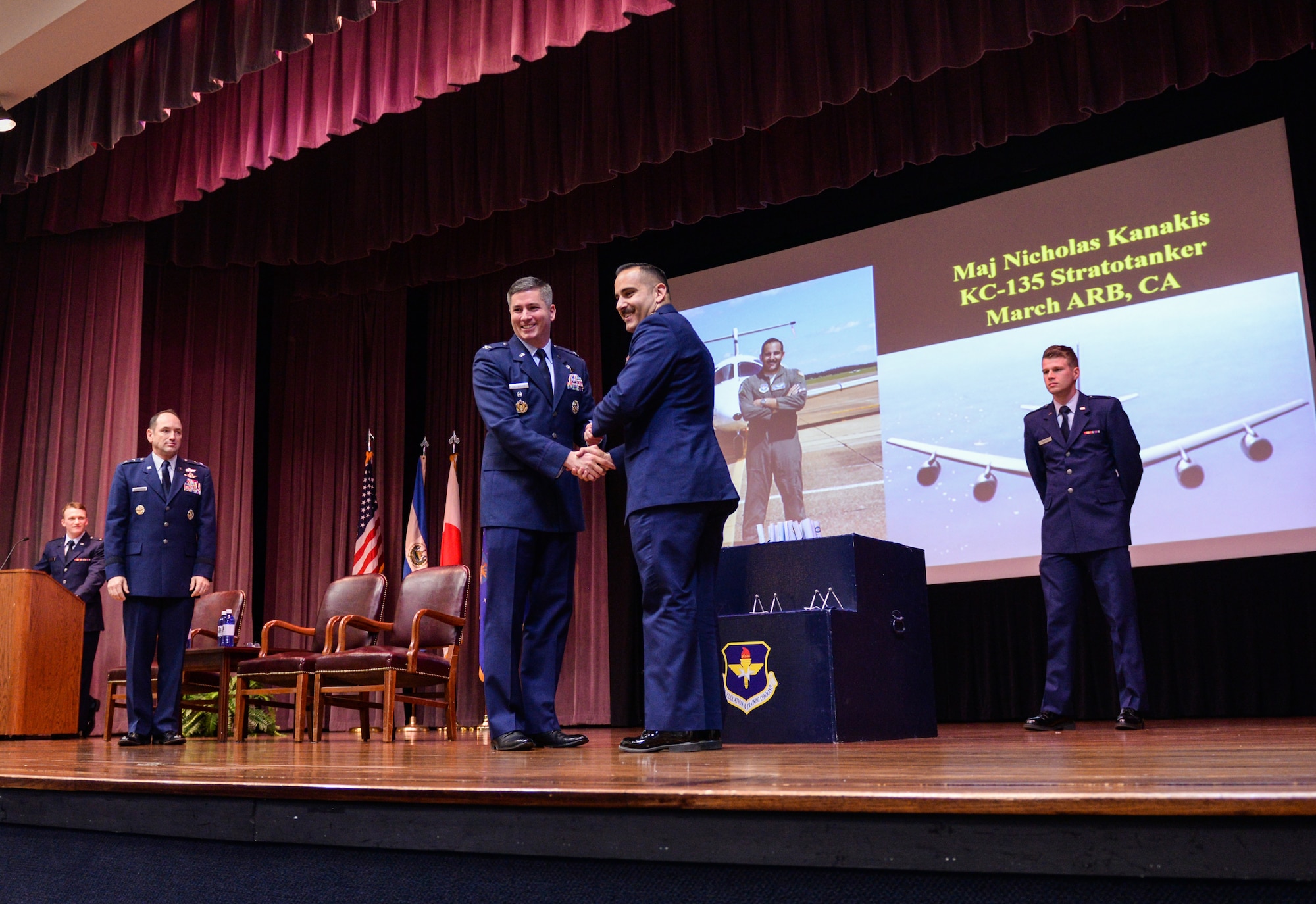 Col. David Fazenbaker, 14th Flying Training Wing vice commander, hands Maj. Nicholas Kanakis, Specialized Undergraduate Pilot Training Class 20-08/09 graduate, his graduation certificate Feb. 28, 2020, at Columbus Air Force Base, Mississippi. Student pilots at Columbus AFB train more than a year before graduating from SUPT. (U.S. Air Force photo by Airman Davis Donaldson)