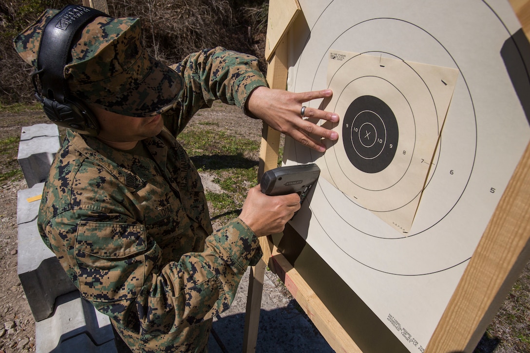 U.S. Marine Corps Gunnery Sgt. Alex R. Diaz, retail operations chief for Marine Corps Community Services, Headquarters and Support Battalion, Marine Corps Installations East, Camp Lejeune, staples on a new target point during the 2016 intramural rifle and pistol competition on Stone Bay Rifle Range, Camp Lejeune, N.C., March 8.