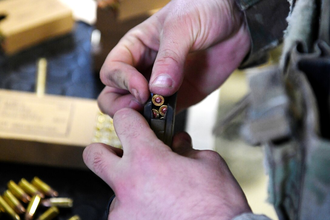 Staff Sgt. Don Hawk, 11th Security Support Squadron resource protection manager, loads an M4 carbine magazine as part of the Defender Challenge 2020 tryouts on Joint Base Andrews, Md., Feb. 27, 2020. JBA defenders competed for an opportunity to represent Air Force District of Washington team in the DC2020 in Camp Bullis, San Antonio, Texas. The challenge will give the Air Force and partnering allies such as the Royal Air Force, the German Luftwaffe, the Royal Australian Air Force and the Royal Canadian Air Force a way to showcase their military police capabilities and joint interoperability. (U.S. Air Force photo by Staff Sgt. Andrew Walck)