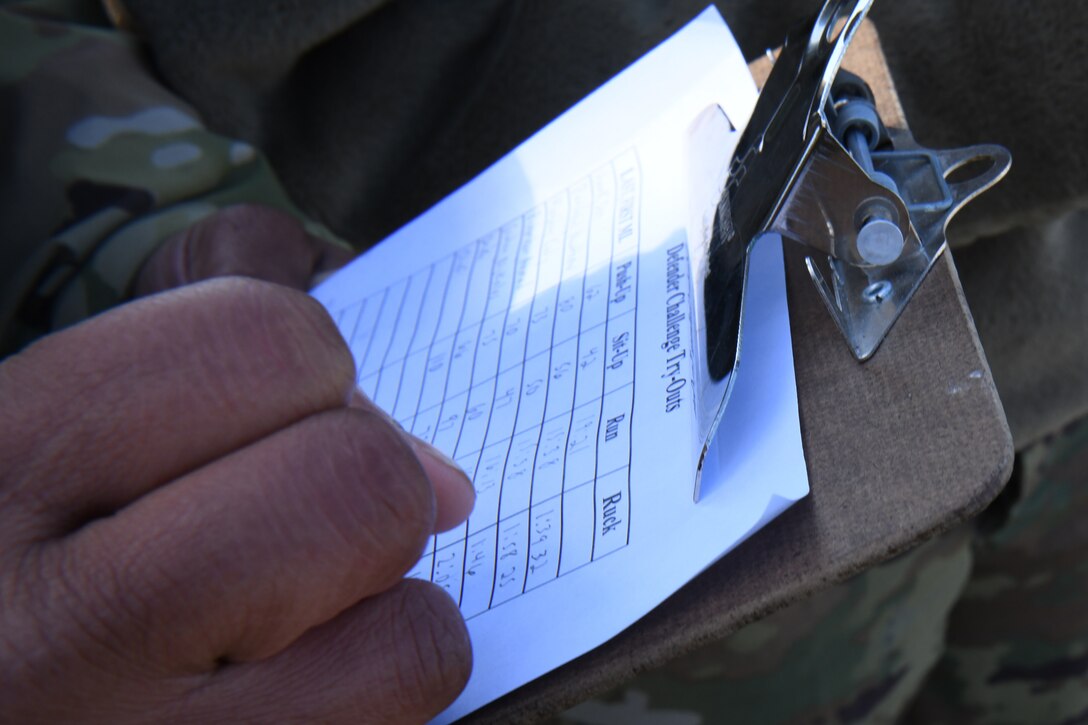 A security forces Airman writes down final scores and times for the physical fitness portion of the Defender Challenge 2020 tryouts at Joint Base Andrews, Md., Feb. 27, 2020. Defenders fought to get one of the seven positions on the team going to Camp Bullis, San Antonio, Texas, to represent Air Force District of Washington in the Defender Challenge 2020. (U.S. Air Force photo by Staff Sgt. Jason Huddleston)