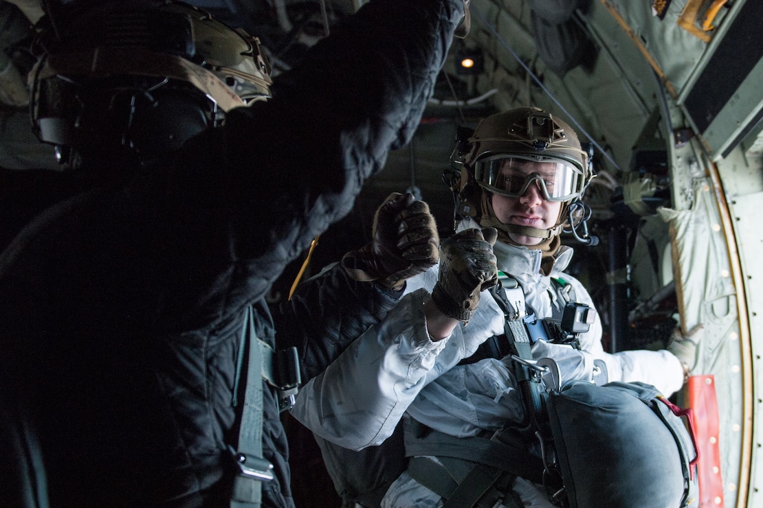 U.S. Air Force Tactical Air Control Party Airmen bump fists before parachuting into Kiruna, Sweden, prior to Exercise Cold Response 20, Feb. 27.