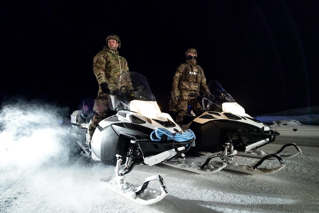 British Royal Marines Commandos prepare to load snowmobiles onto a C-130J Super Hercules at an airport in Bardufoss, Norway, prior to Exercise Cold Response 20.