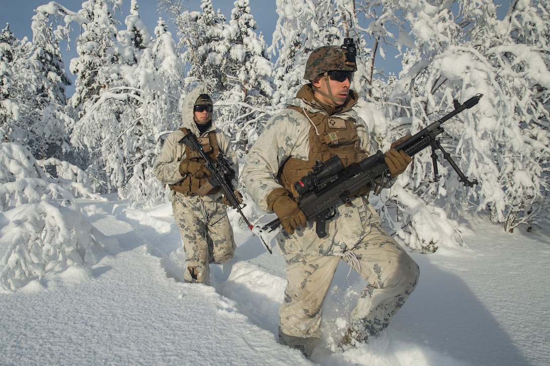 U.S. Marines rush through the tree line during exercise Snow Panzer in Setermoen, Norway, Feb. 25.