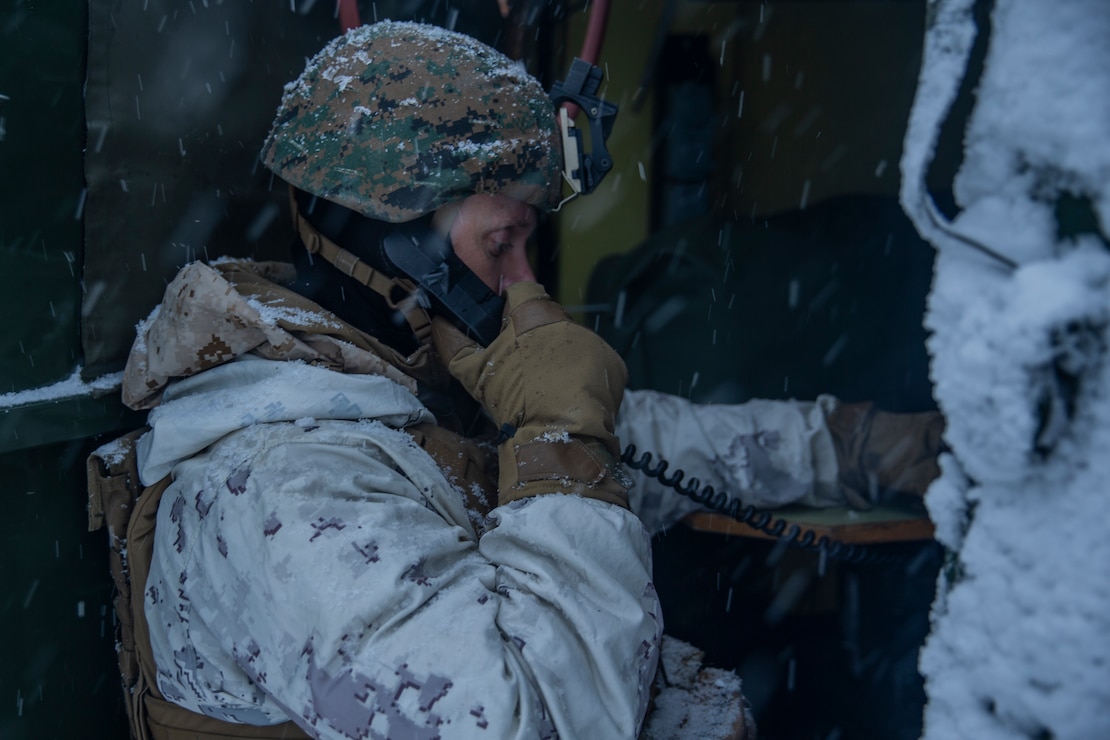 A U.S. Marine radios the location of enemy forces during exercise Snow Panzer in Setermoen, Norway, Feb. 25.