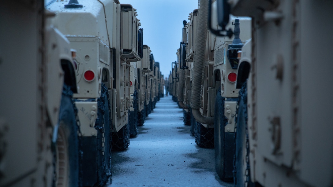 U.S. Marine Corps High Mobility Multipurpose Wheeled Vehicles from the MCPP-N caves are staged at Vӕrnes, Norway, Feb. 13.