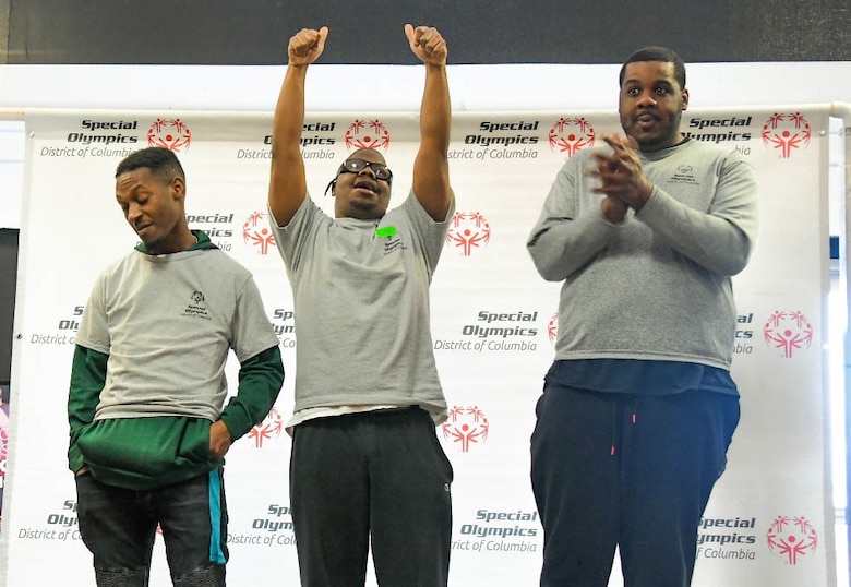 Lenny Haynes, Ellery Roberts, and Cervante Givens, participants on the Special Olympics DC Adult Bowling Tournament, celebrate their success during the tournaments award ceremony in Hyattsville, Md., March 4, 2020. The Special Olympics DC holds a 3-day-long adult bowling tournament each year for disabled adults. (U.S. Air Force photo/Senior Airman Jalene A. Brooks)