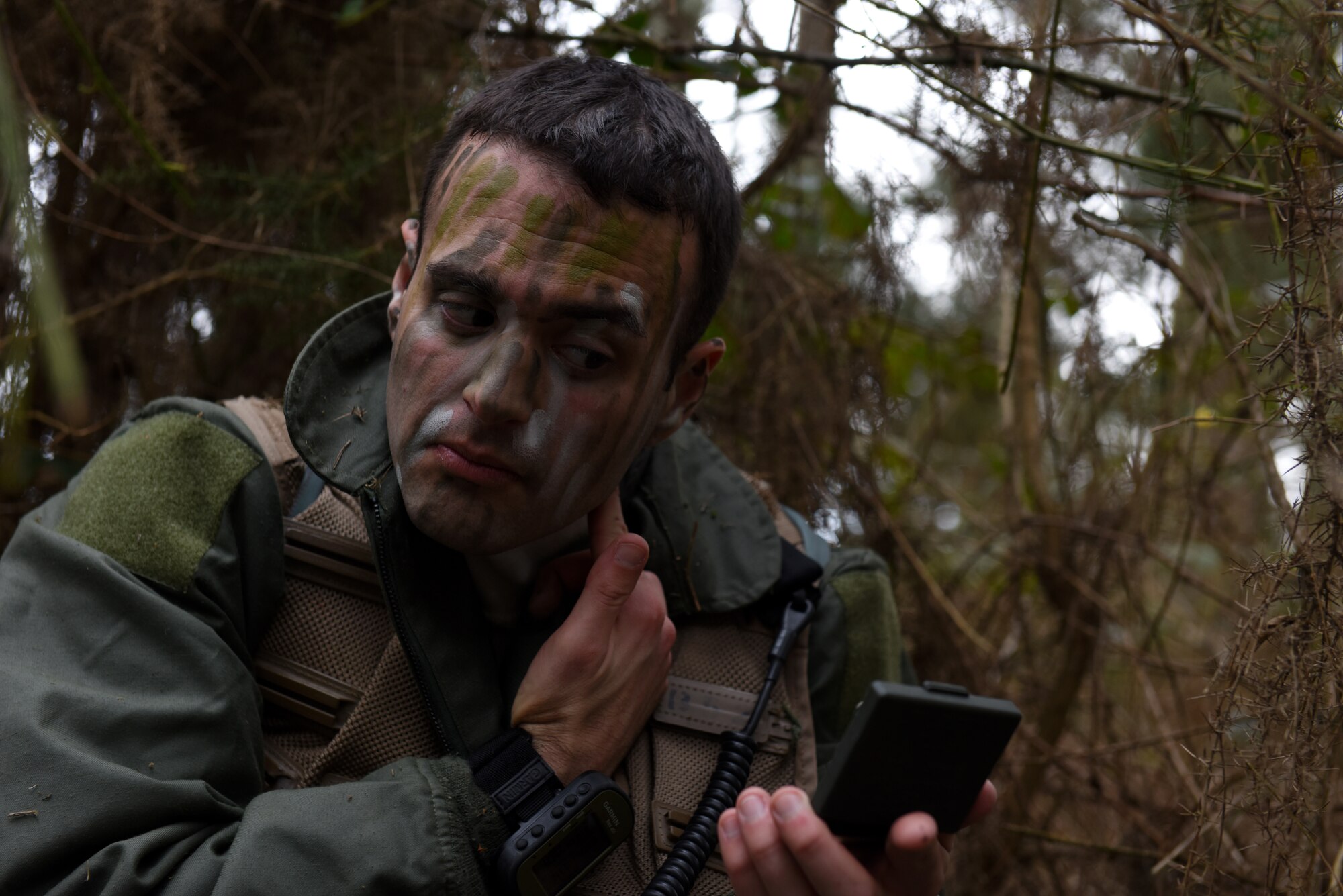 A 48th Fighter Wing Airman applies camouflage face paint during a Survival, Evasion, Resistance, and Escape training course at Stanford Training Area near Thetford, England, March 4, 2020. Camouflage face paint allows class participants to blend into their surroundings which is critical when evading capture. (U.S. Air Force photo by Airman 1st Class Rhonda Smith)