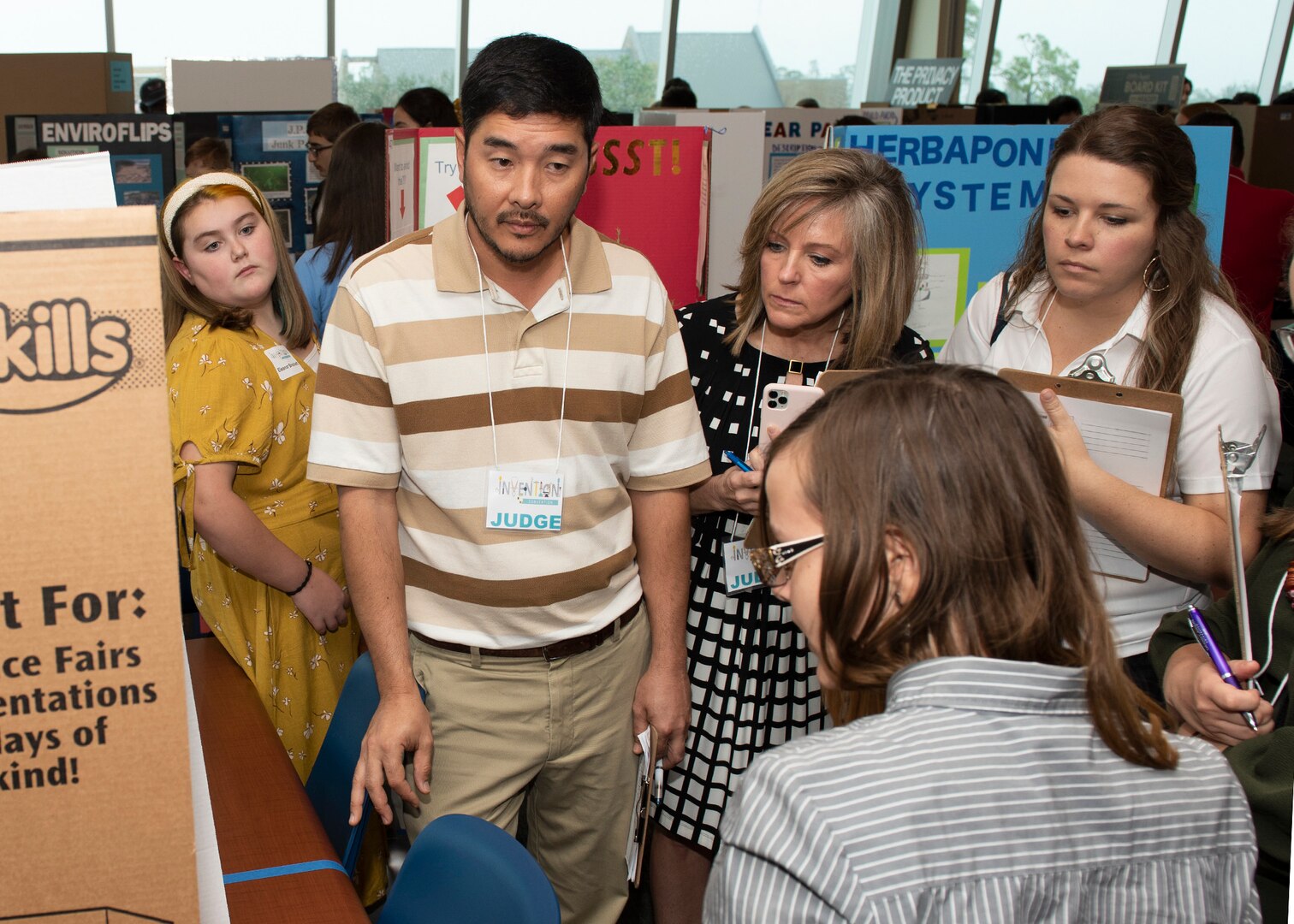 Scientists and engineers from Naval Surface Warfare Center Panama City Division (NSWC PCD) and personnel from other organizations served as judges for this year's Invention Convention. Allie Williams, right, serves as an engineer at NSWC PCD