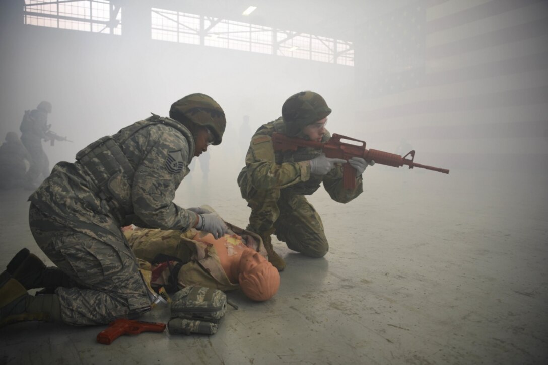 Two airmen participate in a medical exercise.