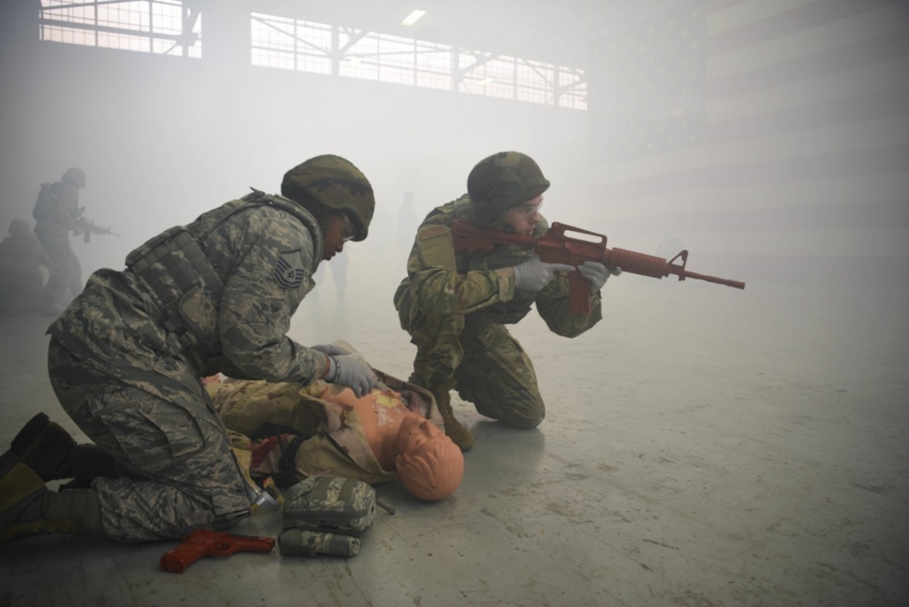 Two airmen participate in a medical exercise.