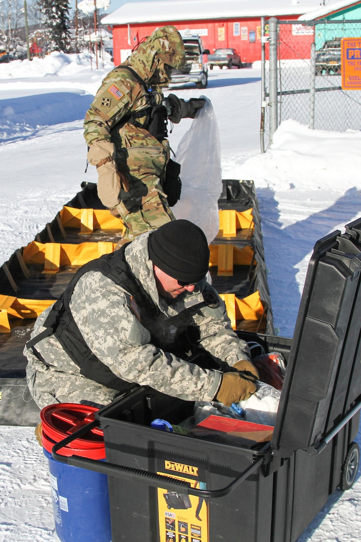 Staff Sgt. Robert Mingolla (front), and Staff Sgt. Sara Macpherson of the NHNG 12th Civil Support Team prepare the decontamination area during a simulated chemical emergency in Fairbanks Alaska on Feb. 25 as part of Arctic Eagle 2020.