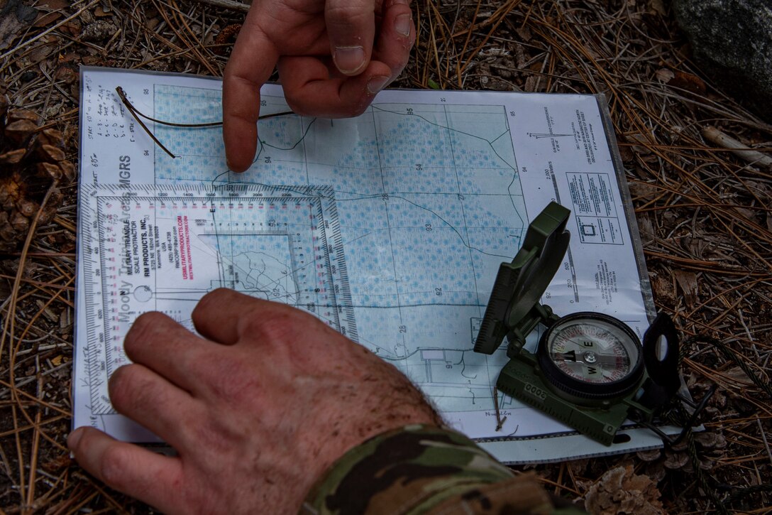 Photo of an Airman pinpointing his location during land navigation training.