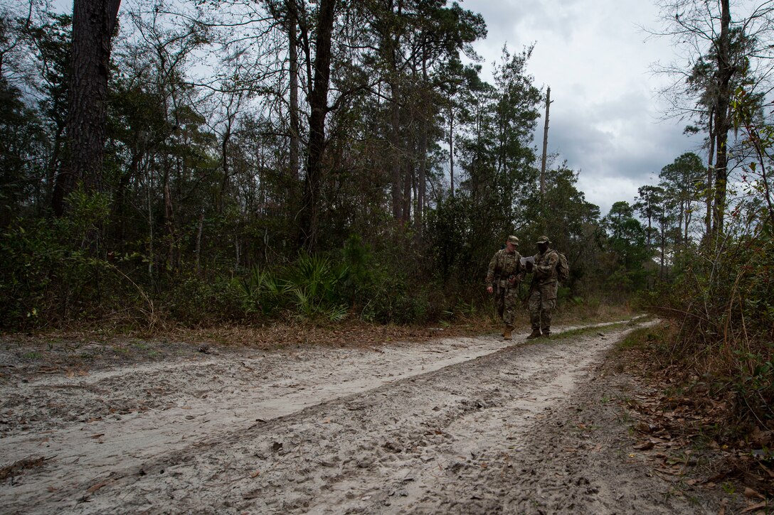 Photo of Airmen walking to a waypoint during land navigation training.