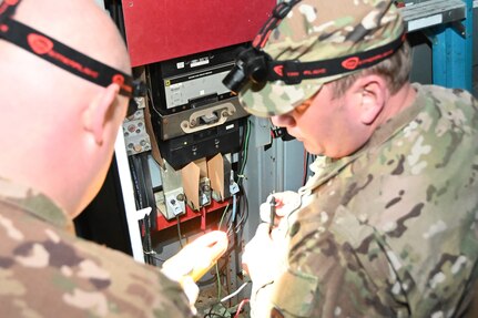 Members of the 118th Civil Engineer Squadron, Tennessee Air National Guard, examine wiring at a water treatment facility March 3, 2020, in Gainesboro, Tennessee. Several 118th CES Airmen mobilized on just a few hours notice to answer a call to power the water treatment facility following severe infrastructure damage from the Middle Tennessee tornados.