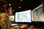 An Airman from the 118th Intelligence, Surveillance, and Reconnaissance Group, Tennessee Air National Guard, examines images of tornado damage across Tennessee March 4, 2020, at Berry Field Air National Guard Base, Nashville, Tennessee. Several Airmen from the 118th ISRG analyzed imagery from commercial satellites and open source websites to determine extent and location of damage caused by the Middle Tennessee tornados.