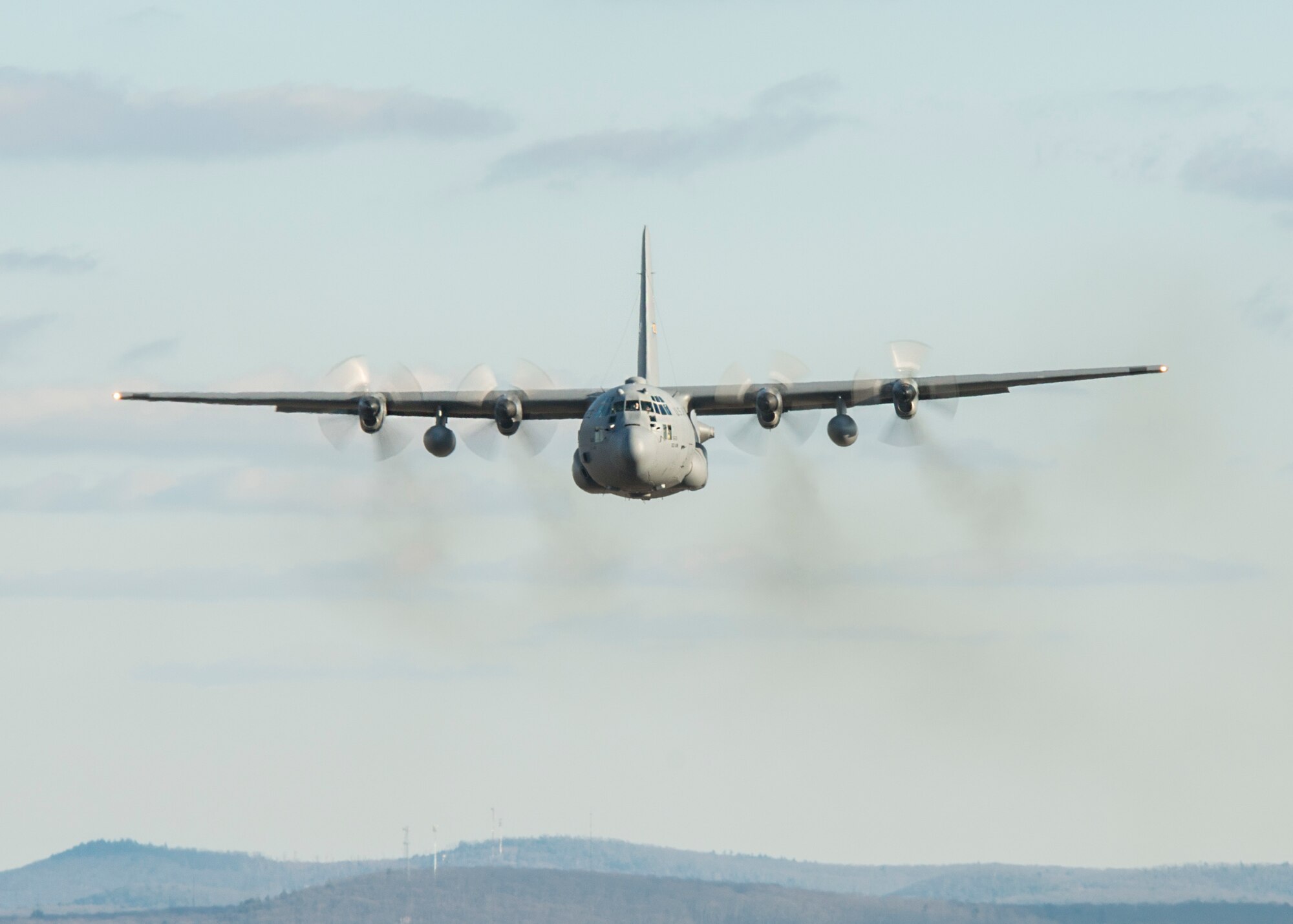 A C-130H Hercules assigned to the 103rd Airlift Wing flies over western Massachusetts, Jan. 15, 2020. Aircrews from the 103rd flew a two-ship formation and conducted airdrops with heavy pallets and container delivery systems, training key tactical airlift capabilities. (U.S. Air National Guard photo by Staff Sgt. Steven Tucker)