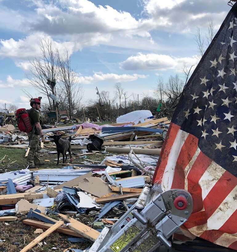 Master Sgt. Rudy Parsons, a pararescueman in the Kentucky Air National Guard’s 123rd Special Tactics Squadron, searches debris fields with Callie, his search-and-rescue dog, in Cookeville, Tenn., March 3, 2019. Parsons and Callie searched for survivors of the multiple tornadoes that hit middle Tennessee earlier that morning, claiming 24 lives. Parsons and Callie — the only certified search-and-rescue dog in the Department of Defense — covered approximate one square mile in five hours. The Dutch shepherd is able to clear rubble piles in minutes using her keen sense of smell, saving hours or days over traditional search-and-rescue methods. (Courtesy Photo)