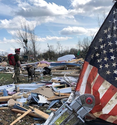 Master Sgt. Rudy Parsons, a pararescueman in the Kentucky Air National Guard’s 123rd Special Tactics Squadron, searches debris fields with Callie, his search-and-rescue dog, in Cookeville, Tenn., March 3, 2019. Parsons and Callie searched for survivors of the multiple tornadoes that hit middle Tennessee earlier that morning, claiming 24 lives. Parsons and Callie — the only certified search-and-rescue dog in the Department of Defense — covered approximate one square mile in five hours. The Dutch shepherd is able to clear rubble piles in minutes using her keen sense of smell, saving hours or days over traditional search-and-rescue methods. (Courtesy Photo)