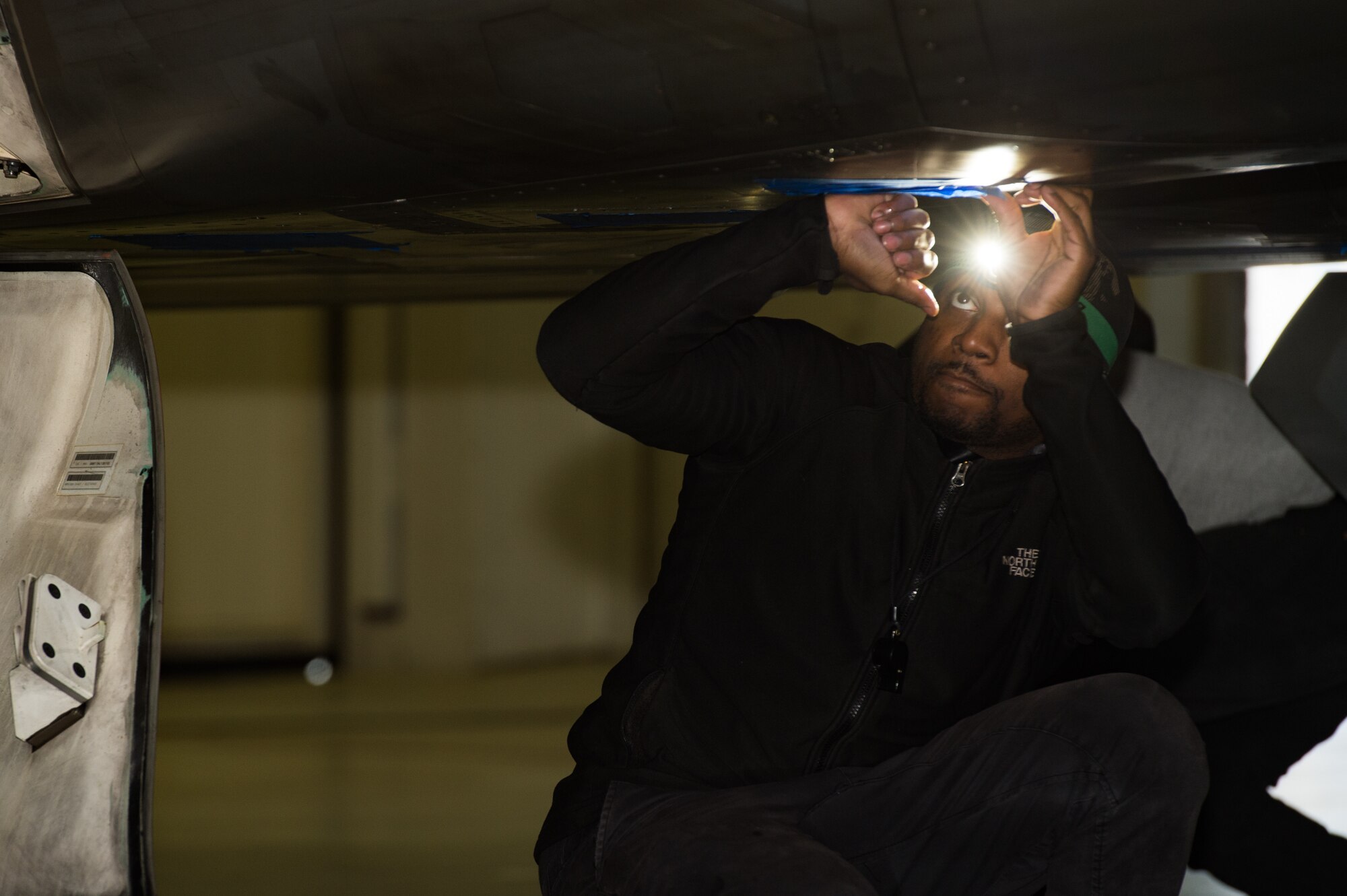 Tavon Best, Shiloh Services Incorporated aircraft wash contractor with the 1st Maintenance Group, washes a U.S. Air Force F-22 Raptor at Joint Base Langley-Eustis, Virginia, Dec 12, 2019.