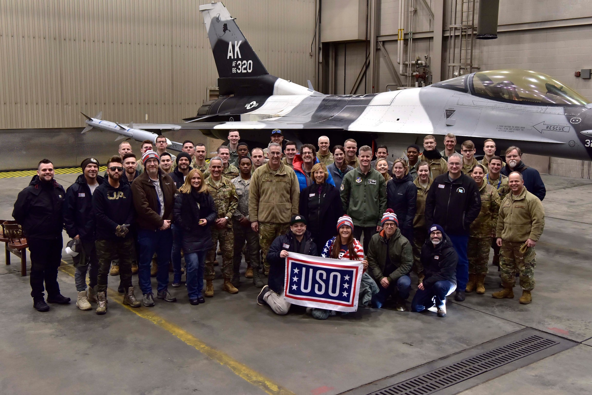 U.S. Air Force Gen. John E. Hyten, Vice Chairman of the Joint Chiefs of Staff, Senior Enlisted Advisor to the Chairman of the Joint Chiefs of Staff Ramón “CZ” Colón-López, and a United Service Organizations tour group pose for a photo with Airmen in front of an 18th Aggressor Squadron F-16 Fighting Falcon on Eielson Air Force Base Alaska, March 2, 2020. The group held multiple meet-and-greets around the base to learn more about Eielson’s mission. (U.S. Air Force photo by Senior Airman Beaux Hebert)