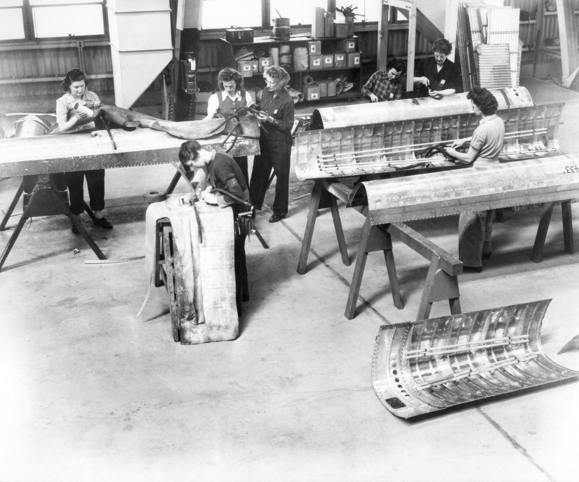 Women working on aircraft panels at Hill AFB during World War II.