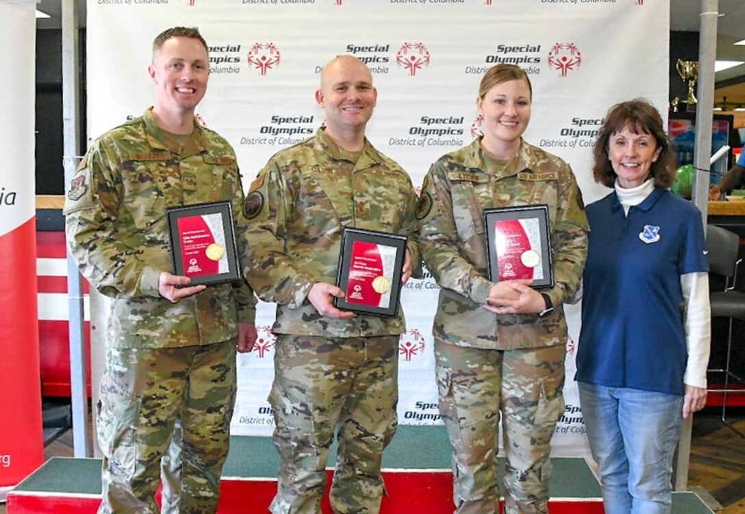 Tech. Sgt. Martin Walcott, 89th Maintenance group; Chief Master Sgt. Matthew Coltrin, Air Force District of Washington; Staff Sgt. Rachel Lycan, Air Force Review Board; and Johanna O'Neill, Air Force District of Washington commander's secretary, pose for a photo after accepting the Special Friend Award on behalf of their units for volunteering at the Special Olympics DC’s Adult Bowling Tournament in Hyattsville, Md., March 4, 2020. The Special Friend Award was awarded to each command that provided more than 10 volunteers on the day of the tournament. (U.S. Air Force photo/Senior Airman Jalene A. Brooks)