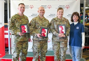Tech. Sgt. Martin Walcott, 89th Maintenance group; Chief Master Sgt. Matthew Coltrin, Air Force District of Washington; Staff Sgt. Rachel Lycan, Air Force Review Board; and Johanna O'Neill, Air Force District of Washington commander's secretary, pose for a photo after accepting the Special Friend Award on behalf of their units for volunteering at the Special Olympics DC’s Adult Bowling Tournament in Hyattsville, Md., March 4, 2020. The Special Friend Award was awarded to each command that provided more than 10 volunteers on the day of the tournament. (U.S. Air Force photo/Senior Airman Jalene A. Brooks)