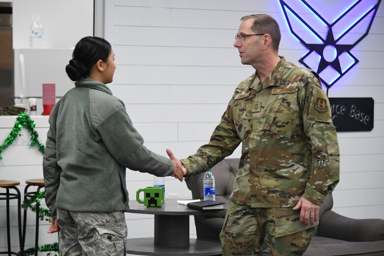 Chief Master Sgt. Stanley C. Cadell, Air Force Materiel Command command chief, presents a coin to Senior Airman Tuyen Nguyen, 75th Medical Group, during an early morning “coffee talk” at Hill Air Force Base, Utah, March 3, 2020. Cadell visited Hill AFB March 1-3 to tour facilities and meet with the base’s Airmen. (U.S. Air Force photo by Cynthia Griggs)