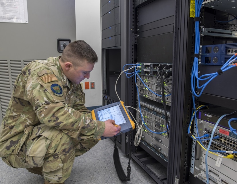 Service member monitors communications circuits.