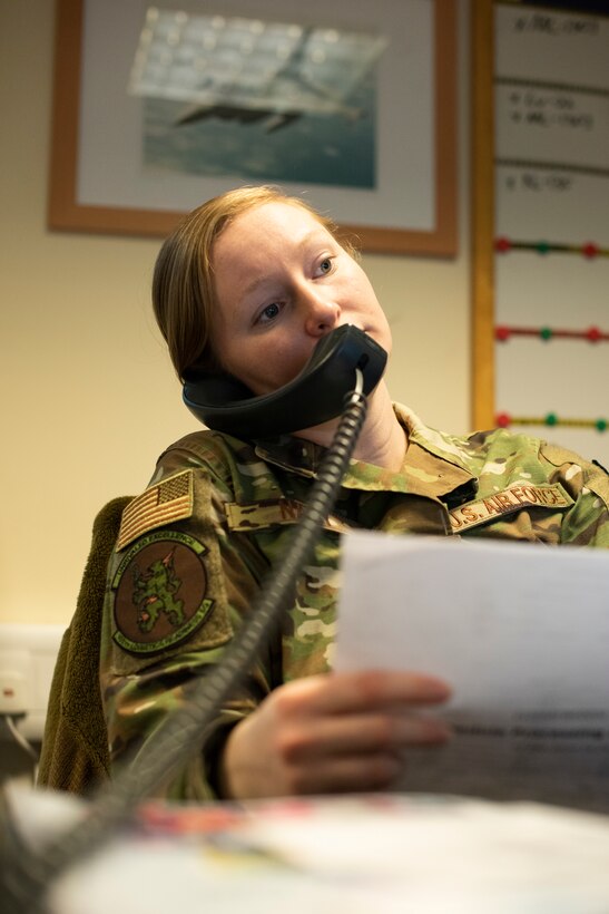 Staff Sgt. Nicole Nagy, 100th Logistics Readiness Squadron wing air expeditionary force reporting tool manager, speaks with a unit deployment manager over the phone March 3, 2020, at RAF Mildenhall, England. The IDRC works closely with unit deployment managers to make sure deploying Airmen are prepared to execute the mission. (U.S. Air Force photo by Airman 1st Class Joseph Barron)