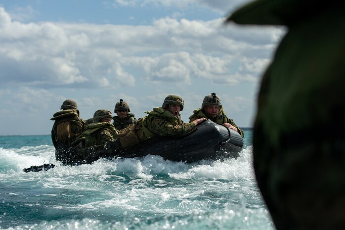 U.S. Marines ride their combat rubber raiding craft toward the Whidbey Island-class dock landing ship USS Germantown (LSD 42.