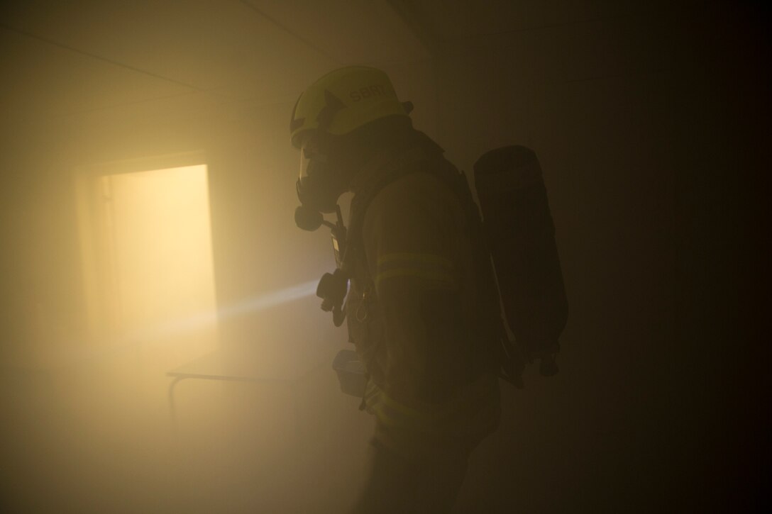 Firefighters from the Stjødal firehouse arrive and respond to a notional fire during an Explosive Ordnance Disposal training event in Stjødal, Norway, Feb. 24.