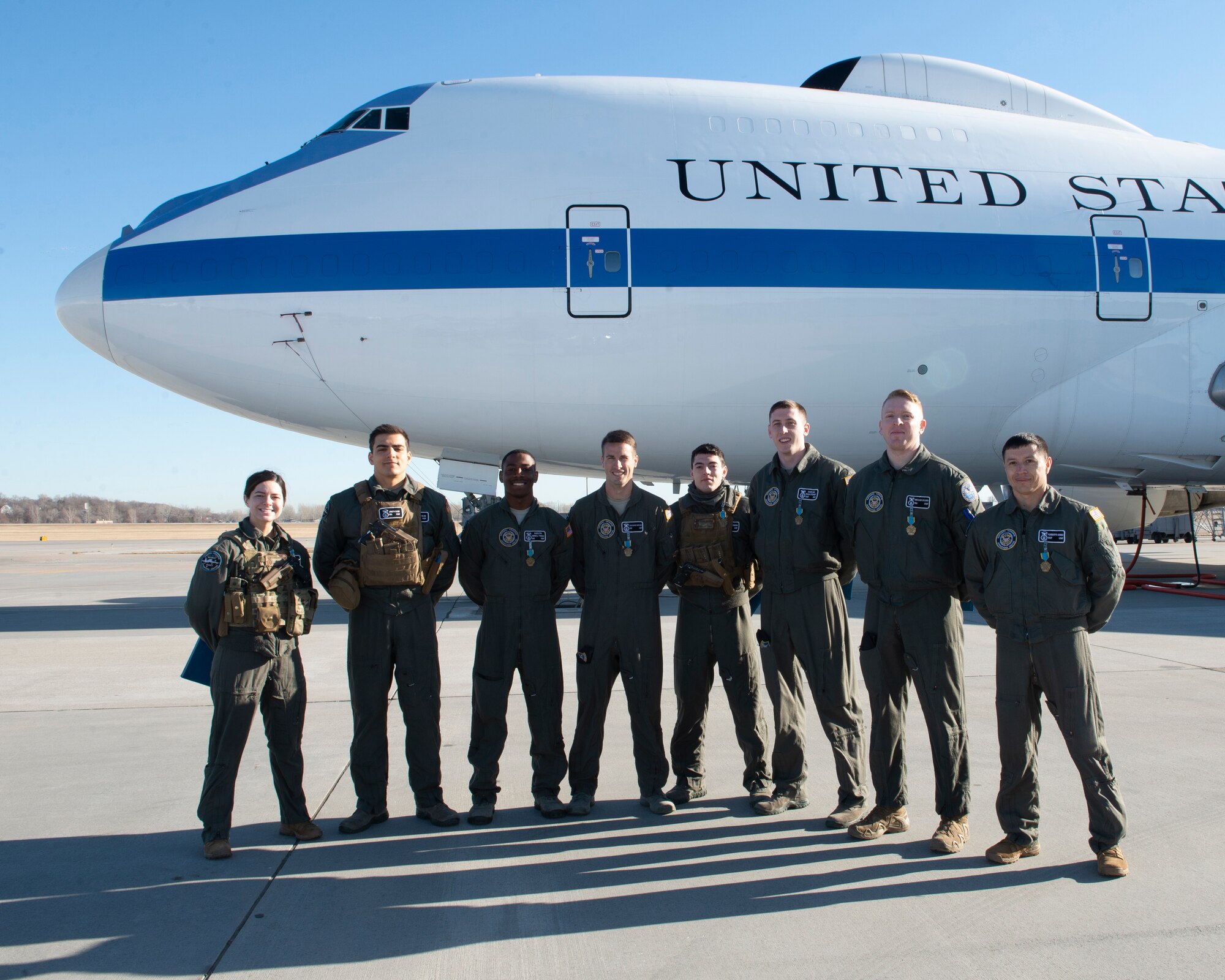 photograph of 8 air force security forces members standing in front of aircraft after winning a medal