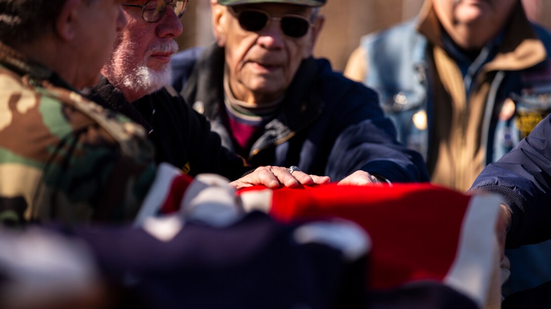 Veterans display a 48-star flag during a ceremony to commemorate the dedication of the National Iwo Jima Memorial in Newington, Conn., Feb. 23.