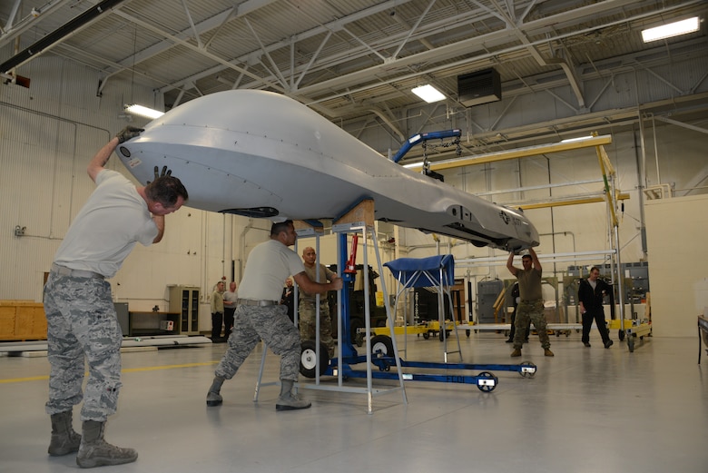 Airmen work on an MQ-1 Predator at the Air National Guard Paint Facility
