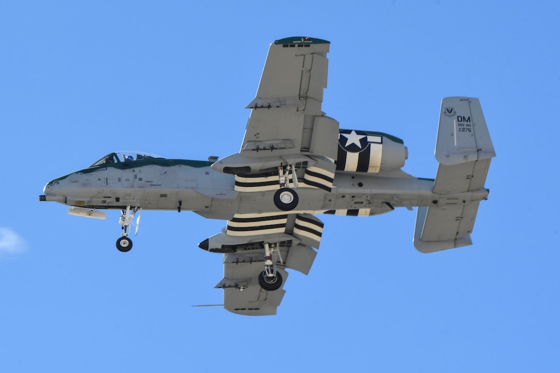 An A-10 Thunderbolt II flies with deployed landing gear