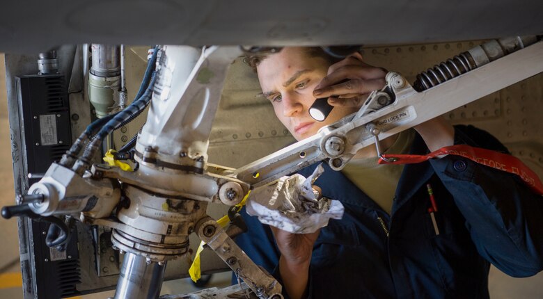 Airman helps with a phase inspection on an F-16 Fighting Falcon