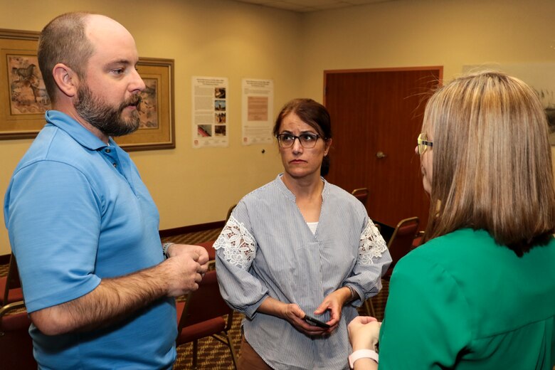 Matt Masten (left), the U.S. Army Corps of Engineers Los Angeles District's Arizona-Nevada Area Office chief of technical and environmental support section, speaks with Rachel Kerr, a geologist and program manager at Ahtna Environmental, Inc., and Fran Firouzi (center), a district project manager for the Installation Restoration Program. The presentation was held under the guise of the Army Defense Environmental Restoration Program as the Installation Restoration Program in this case. The program manager is the Army Environmental Center and USACE supports the program through the local district as the executing agent for environmental remediation at the fort.