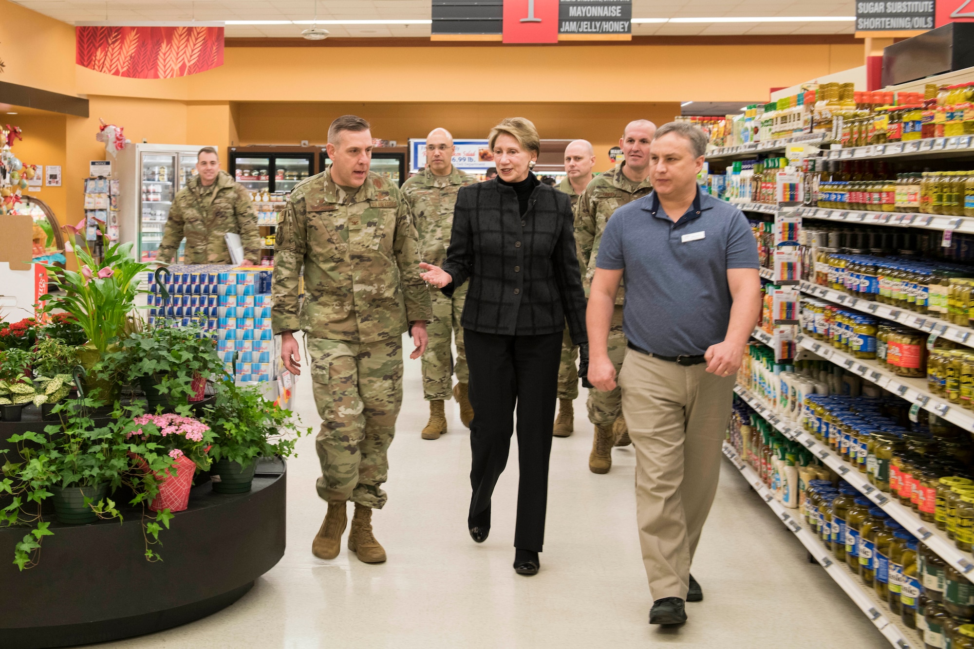 SecAF walks through the Minot AFB commissary with base leadership