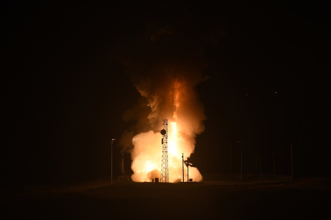 A missile takes off at night.