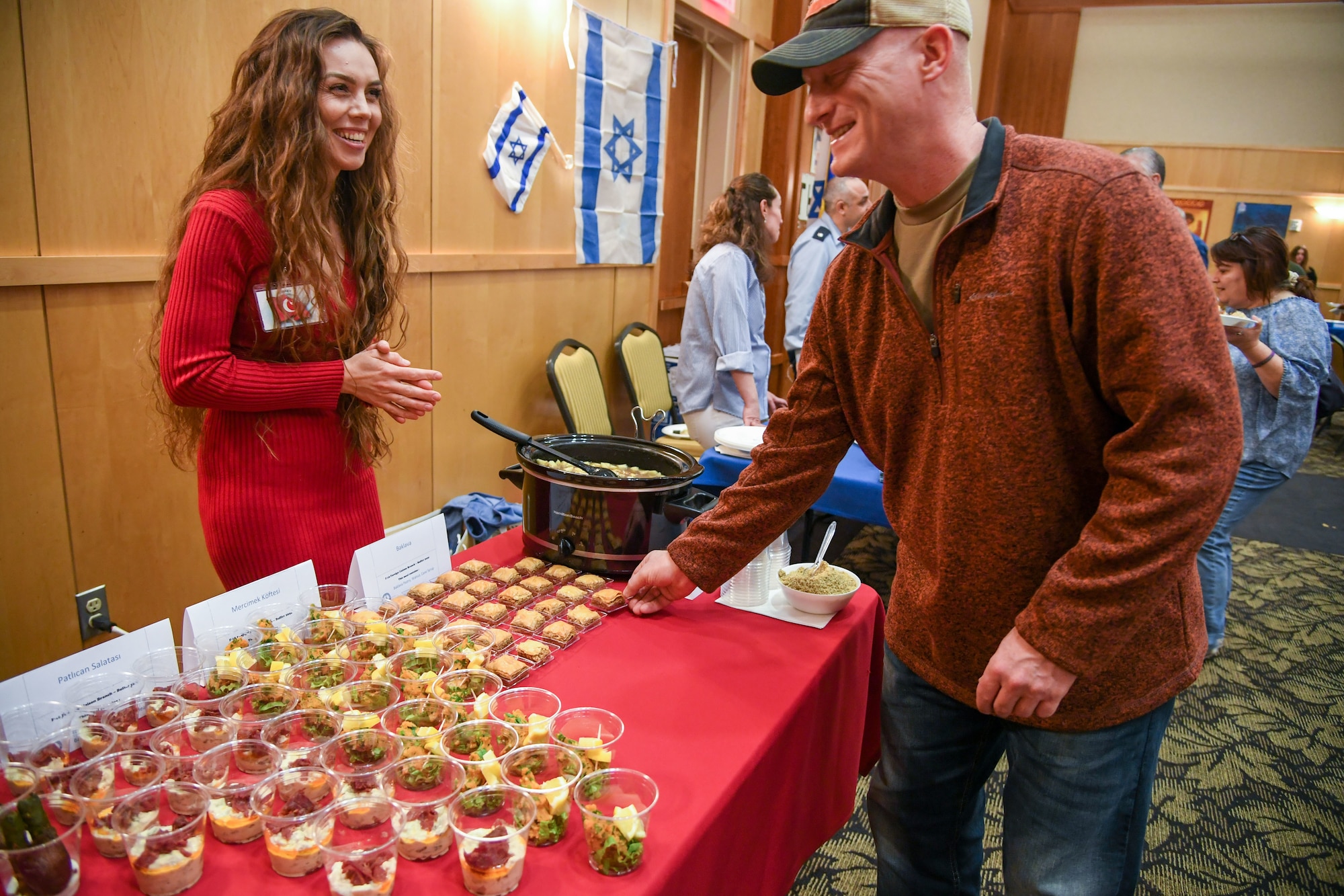 Nurdina Senay, from Turkey, talks about her dishes at the International Culinary Tasting Buffet March 4, 2020, at Hill Air Force Base, Utah. The event was hosted by the Hill AFB foreign liaison officers and featured food, drinks, and cultural education from 15 different countries. (U.S. Air Force photo by Cynthia Griggs)