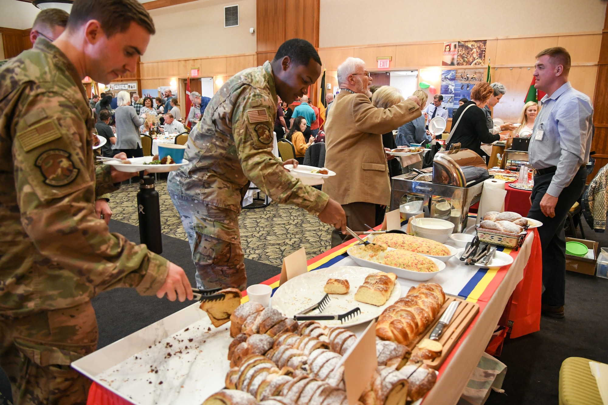 Attendees enjoy pastries and a vegetable casserole at the Romanian table at the International Culinary Tasting Buffet March 4, 2020, at Hill Air Force Base, Utah. The event was hosted by the Hill AFB foreign liaison officers and featured food, drinks, and cultural education from 15 different countries. (U.S. Air Force photo by Cynthia Griggs)