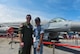 U.S. and Singapore Air Force member stand side by side smiling.