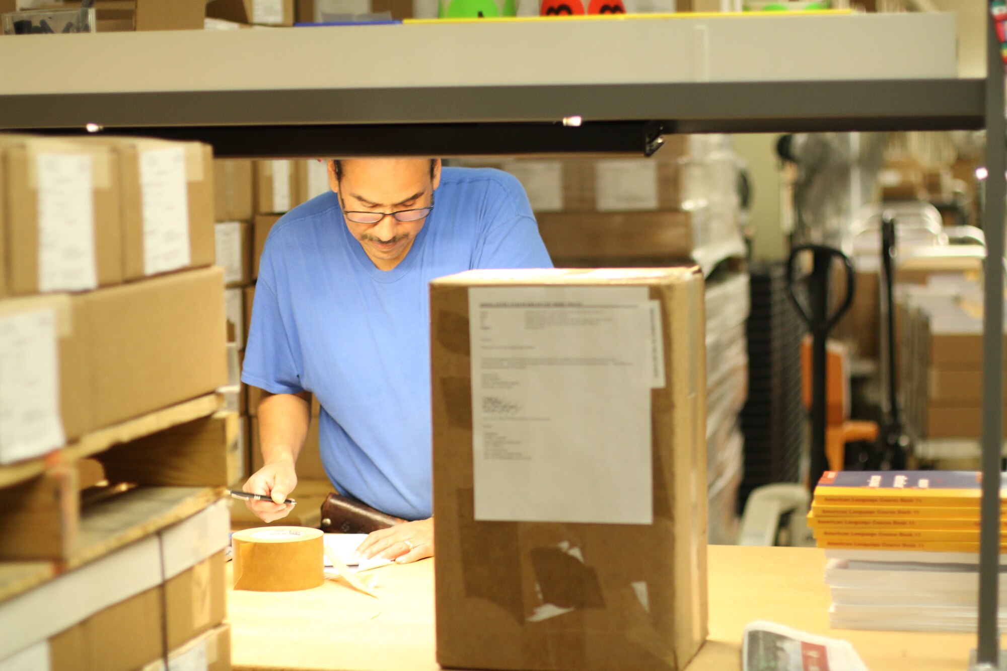 DLIELC Logistics employee, Mr. Ernest Banda, prepares the shipment of course materials for the Vietnam MTT. All course materials were created, designed, and printed in-house. In FY19, DLIELC sent materials to over 160 countries.