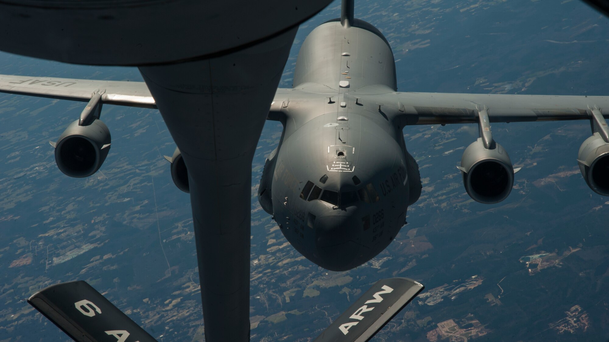 A C-17 Globemaster III approaches a KC-135 Stratotanker during an air refueling