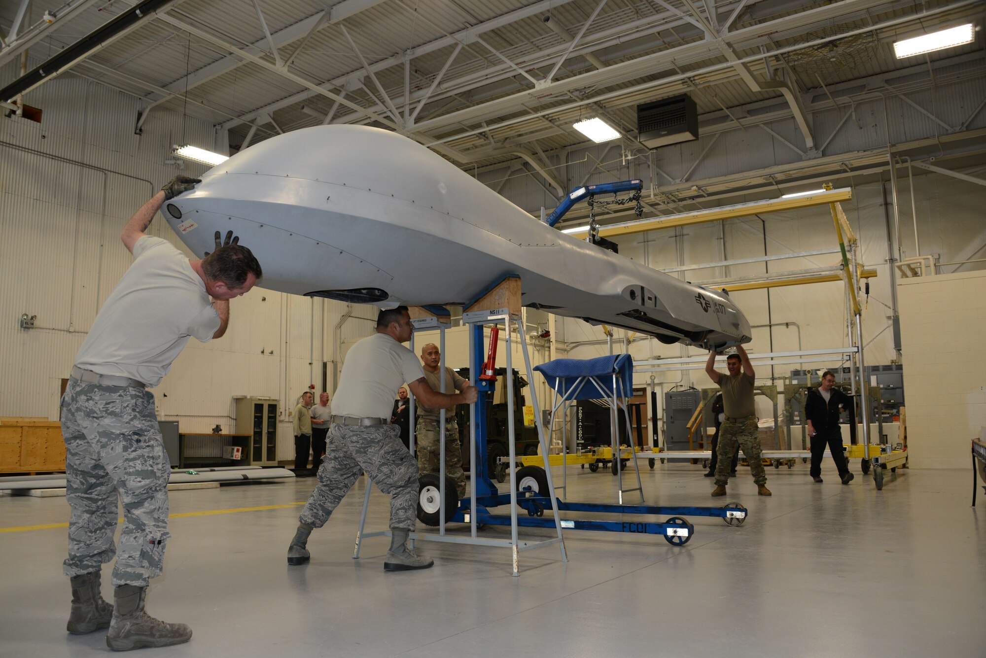 Airmen work on an MQ-1 Predator at the Air National Guard Paint Facility