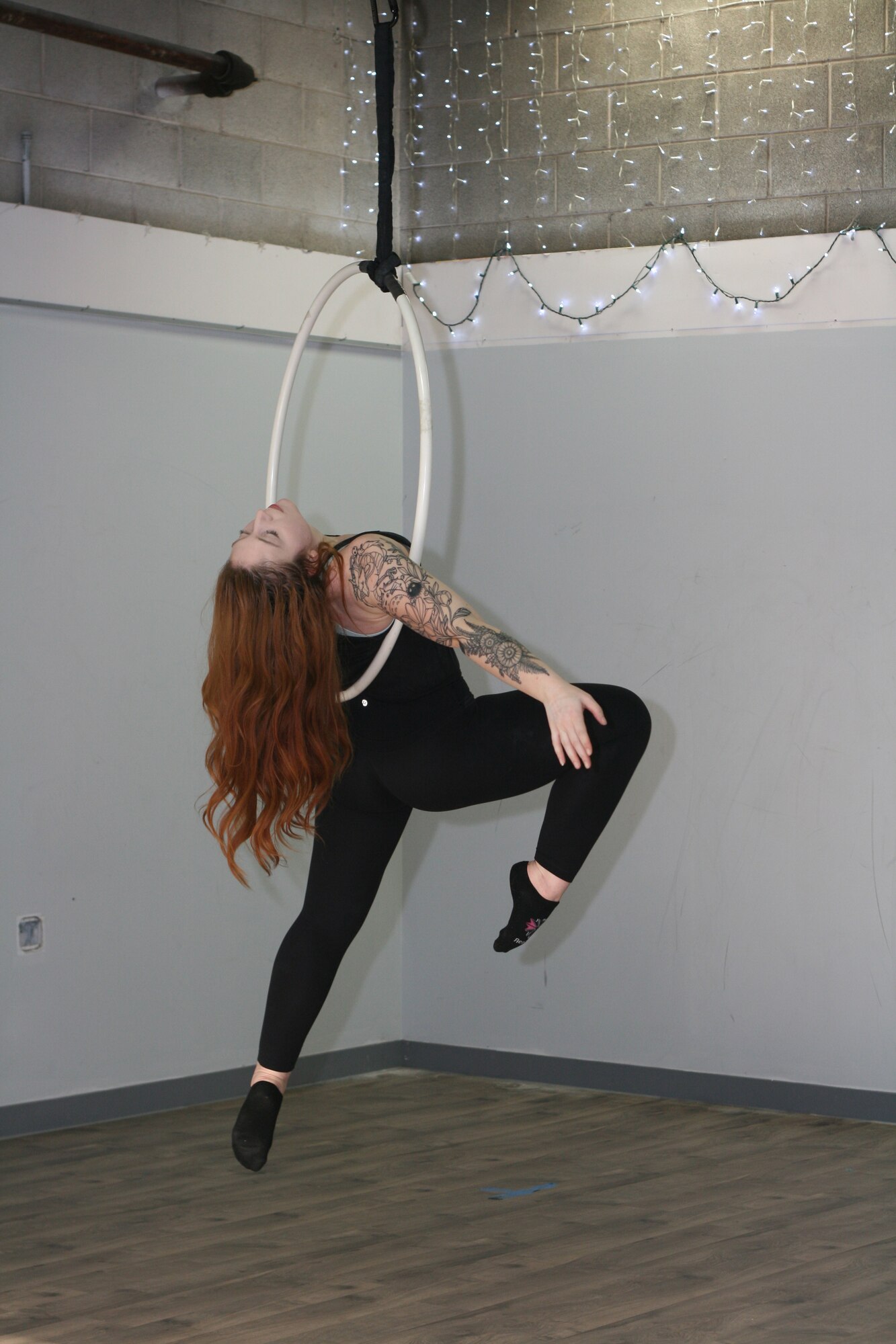 Staff Sgt. Rachel Loftis, a public affairs specialist with the 193rd Special Operations Wing, Middletown, Pa., completes a lyra workout, also known as aerial hoop - the art of performing acrobatics using a hoop connected to the ceiling. Loftis first pursued aerial acrobatics while stationed at Nellis Air Force Base, Las Vegas, which she attributes to the robust local “circus community” there and the desire to find a fitness program that was effective and held her interest. (U.S. Air National Guard photo by Tech. Sgt. Claire Forbes)