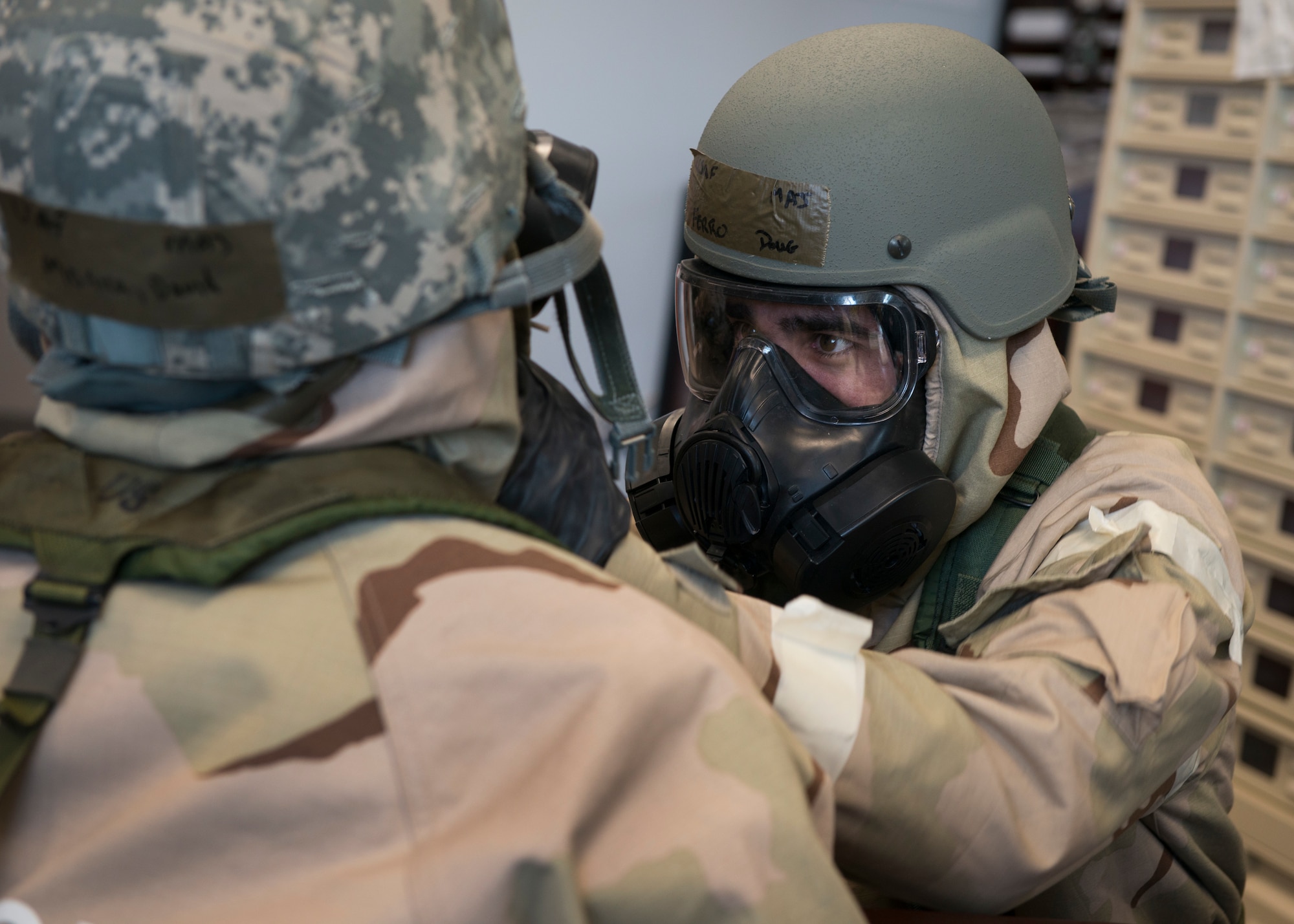 Maj. Doug Ferro, 118th Airlift Squadron pilot, checks Maj. David Monico’s Mission Oriented Protective Posture (MOPP) gear during a large-scale readiness exercise at Bradley Air National Guard Base, East Granby, Conn. March 5, 2020. The exercise tested the 103rd Airlift Wing’s ability to deploy to and sustain in a contested environment. (U.S. Air National Guard photo by Staff Sgt. Steven Tucker)