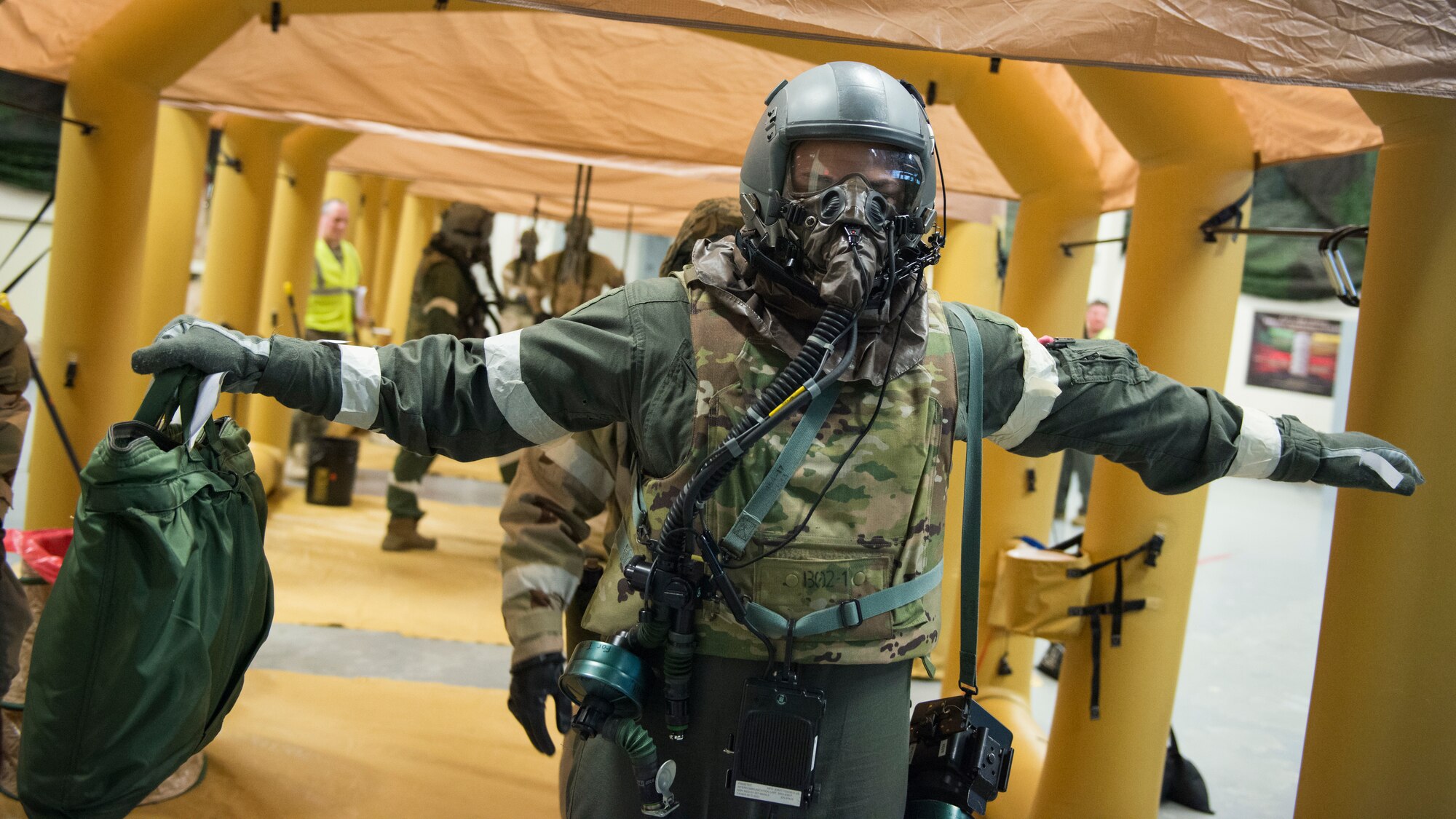 Tech. Sgt. Thomas Buckley, 118th Airlift Squadron loadmaster, is checked for contamination on his aircrew eye and respiratory protection system (AERPS) equipment during a large-scale readiness exercise at Bradley Air National Guard Base, East Granby, Conn. March 5, 2020. The exercise tested the 103rd Airlift Wing’s ability to deploy to and sustain in a contested environment. (U.S. Air National Guard photo by Staff Sgt. Steven Tucker)
