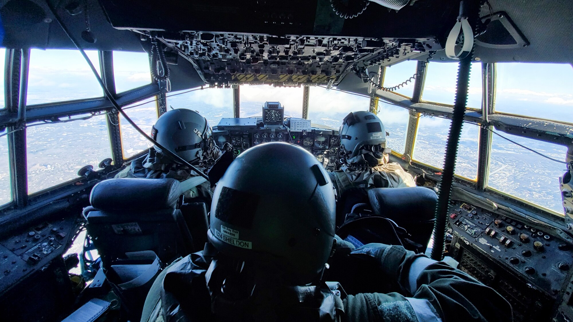 Maj. Doug Ferro, 1st Lt. Zachary Smith, 118th Airlift Squadron pilots, and Master Sgt. Brian Sheldon, 118th Airlift Squadron flight engineer, fly to Pease Air National Guard Base, Newington, NH while wearing aircrew eye and respiratory protection system (AERPS) equipment during a large-scale readiness exercise held at Bradley Air National Guard Base, East Granby, Conn. March 5, 2020. The exercise tested the 103rd Airlift Wing’s ability to deploy to and sustain in a contested environment. (U.S. Air National Guard photo by Staff Sgt. Steven Tucker)